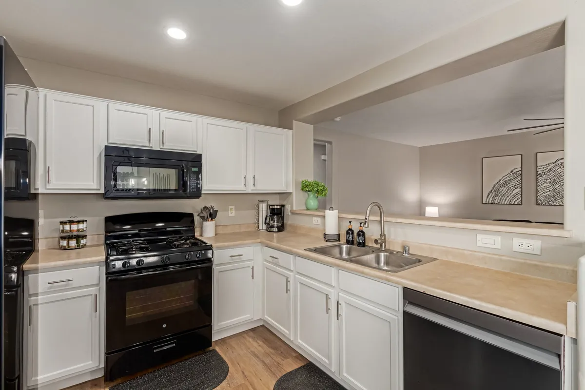 A bright, fully equipped kitchen with modern appliances, ample countertops, and spacious cabinets. The scene captures a welcoming environment ideal for cooking, socializing, and shared family meals after a day of activities.