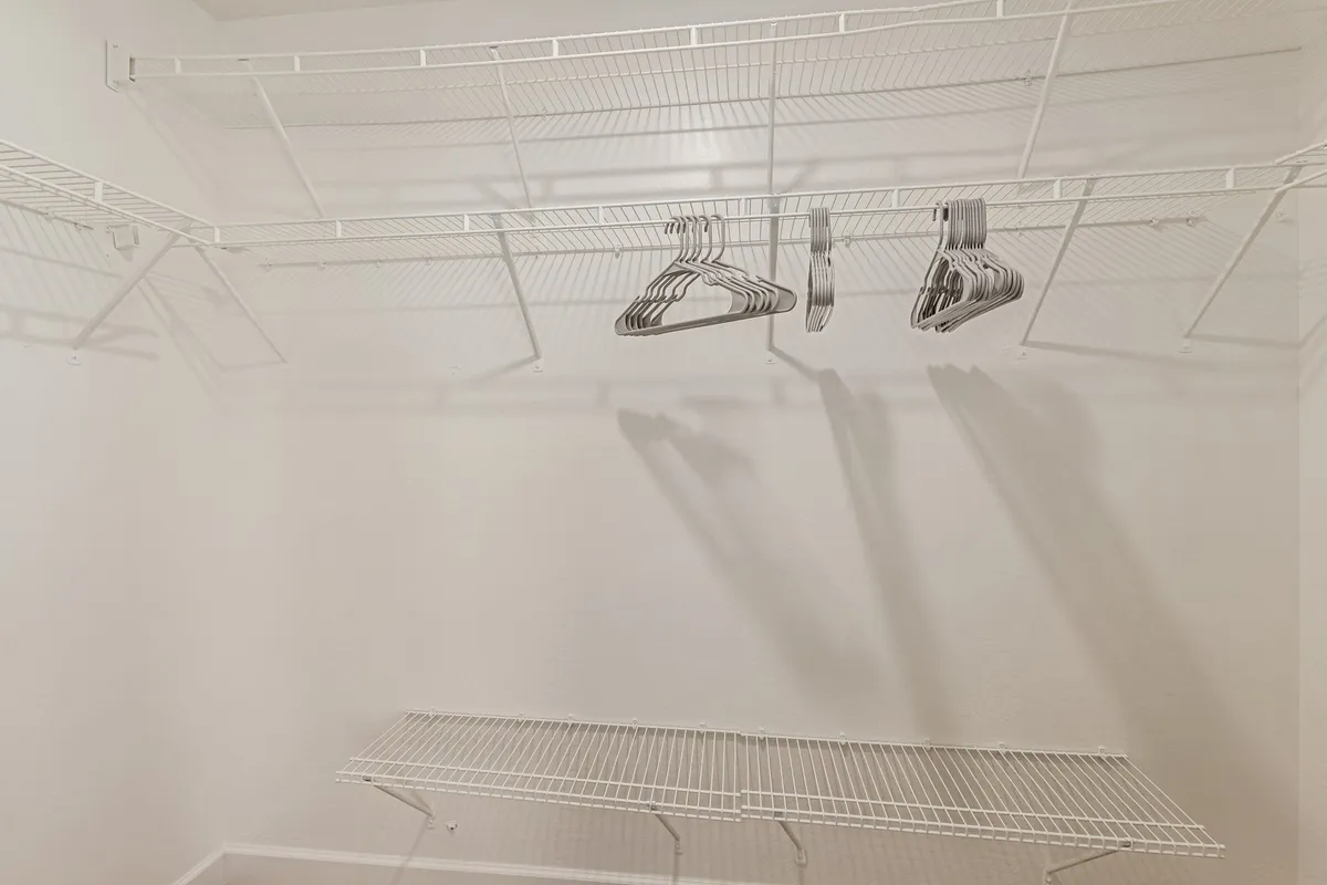 A well-organized closet with ample wire shelving and hangers, perfect for storing clothes and personal belongings during an extended stay. It offers a glimpse of practical organization and daily living.